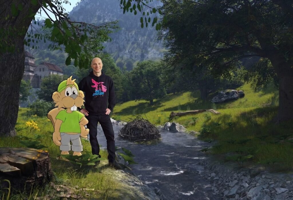 A smiling person stands beside a cartoon character in a lush, mountainous landscape with a stream and trees, exuding a whimsical, joyful tone.