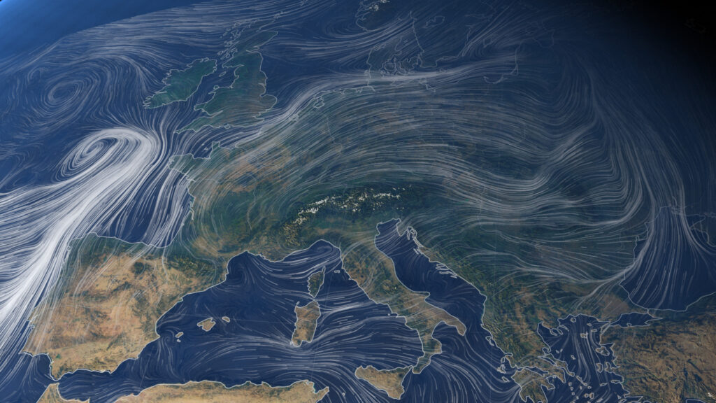 Satellite view of Europe with swirling wind patterns marked by white lines. The image shows vast atmospheric movement, conveying dynamic, fluid motion over land and sea.